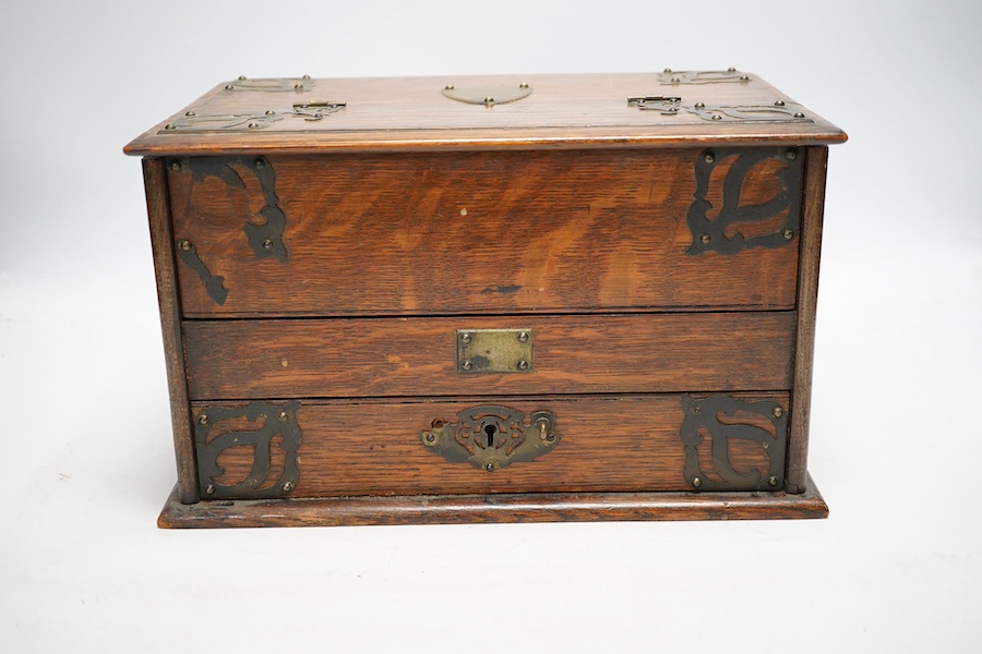 An early 20th century jewellery box and a similar oak stationery casket. Condition - poor